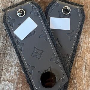 Gray embossed vinyl on black leather Apple Watch band